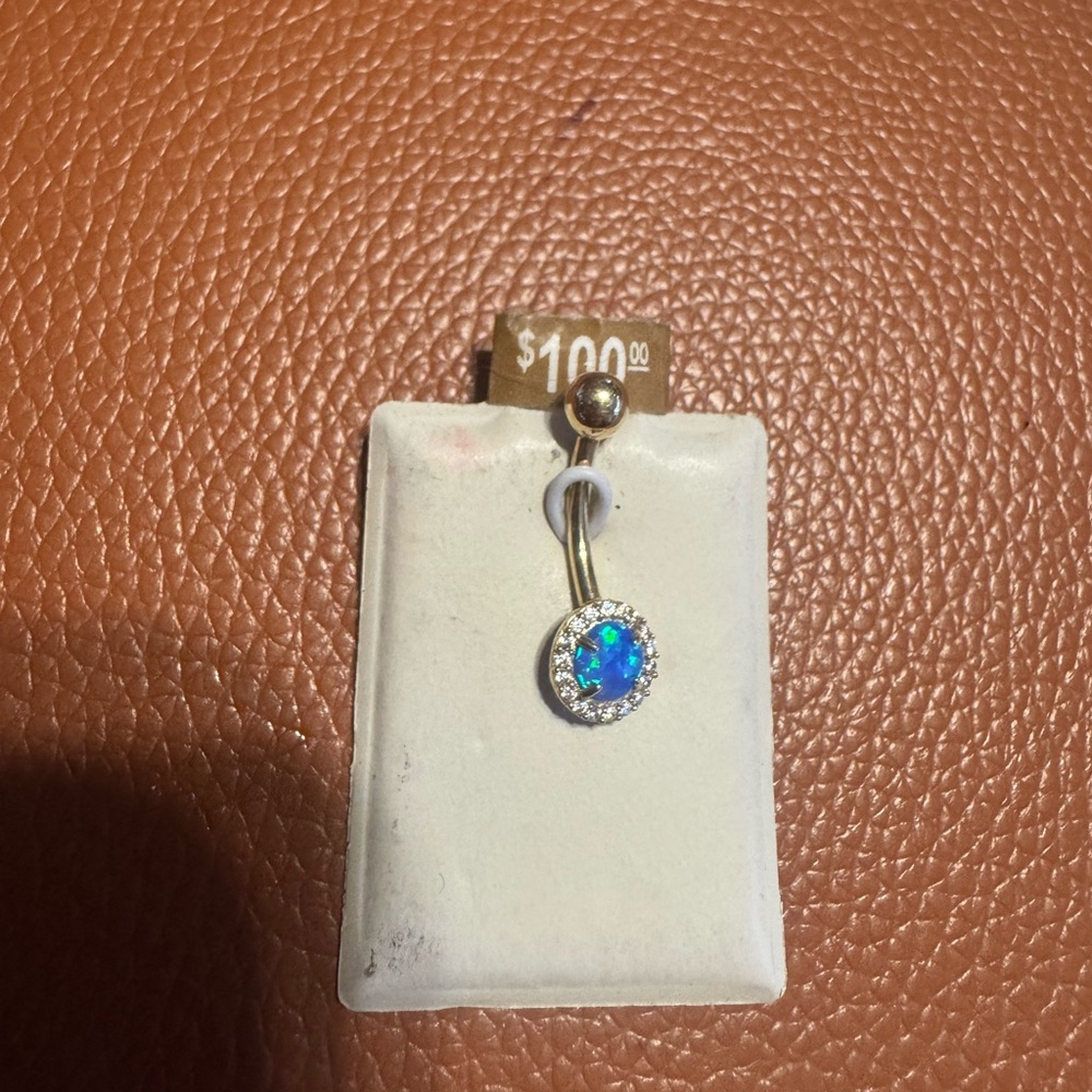 Beautiful New never worn belly button ring. 10K yellow gold sapphire stone